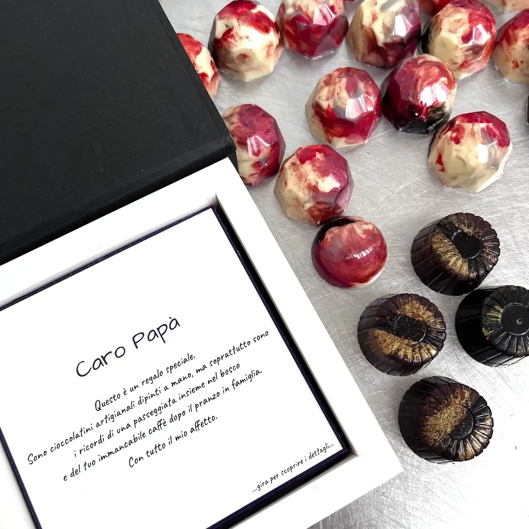 Caro Papà collection — hand-painted pralines with forest and coffee themes in an elegant box