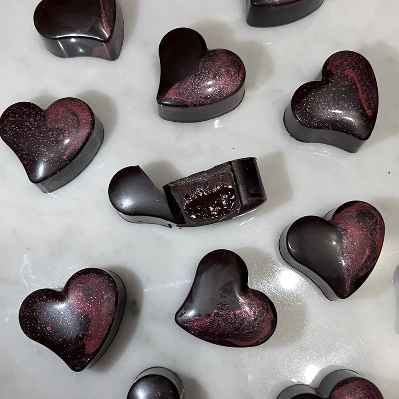 Lampone in Nero heart-shaped bonbon with elegant hand decorations
